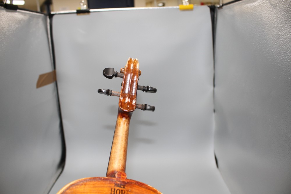 A violin with two piece back and bow, and a childs violin with bow, both with cases